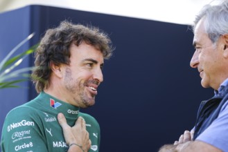 MELBOURNE, AUSTRALIA - MARCH 13: Fernando Alonso of Spain and Aston Martin Aramco F1 Team talks to
