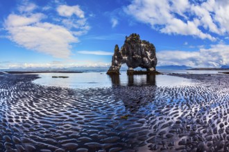 The north coast of Iceland. Ocean tide at sunset. Rock Hvitserkur on the sea beach in the form of a