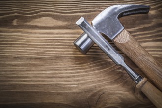 Claw hammer flat chisels on vintage wood board