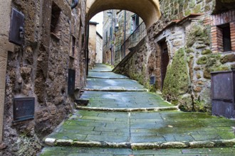 The tuff city of Sorano. Narrow street and covered bridge. Etruscan towns of Tuscany. Towns that