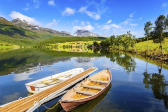 Summer trip to Norway. The lovely and calm lake Eidsvatnet. Several boats are tied up near the
