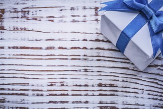 Wrapped present box on vintage wooden board holidays concept