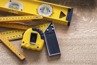 Oaken board with wooden meter measuring line construction level and square ruler maintenance