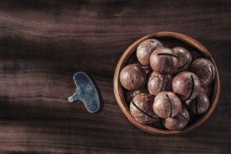 Macadamia Nuts In Wooden Bowl Key For Open On Vintage Wood