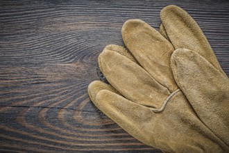 Pair of safety gloves on vintage wooden board top view agriculture concept
