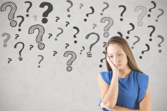 Bored and sad woman with lots of doubts and question marks around her
