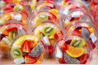 Colorful natural fruit salad transparent glasses in a row