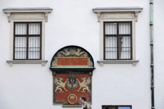 Historic building façade with two windows and a coat of arms, Vienna, Austria, Europe
