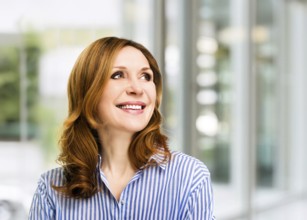 Smiling confident stylish mature middle aged woman at office. Senior businesswoman, executive