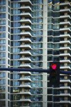 A multi-storey apartment building and tower block with symmetrically arranged balconies and a