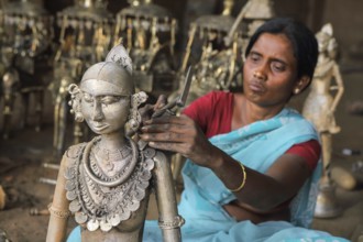 Woman crafting handicrafts out of wrought iron, bastar, chhattisgarh, india, asia