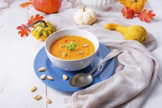 Healthy pumpkin soup with ginger carrots and coconut milk