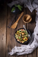 Pasta salad with green asparagus, olives and Parma ham