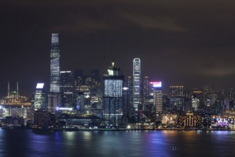 Symphony of Lights in night Hong Kong. Illuminated skyscrapers and colorful reflection in water
