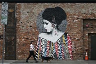 Passers-by in front of a mural on Selma Avenue, Hollywood, Los Angeles, California, USA, North