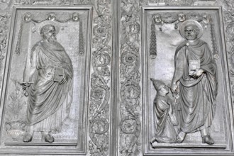 Detailed relief of figures of saints surrounded by biblical symbols, Rome, Lazio, Italy, Europe
