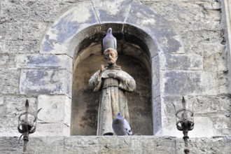Assisi, Umbria, Italy, Europe, stone altar with a statue of a saint in the niche, decorated with