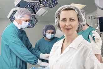 Adult female anesthetist with syringe on the surgery teem background