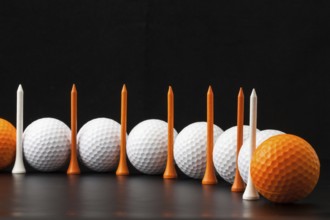 Different golf balls on the black table