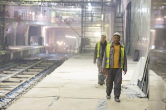 Sofia, Bulgaria - April 19, 2016: Two underground subway tunnel workers are going for lunch during