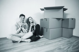 Relocated couple drinking tea on the floor