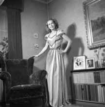 Fashion of 1946. A woman pictured wearing the typical fashion of the postwar era. She is wearing a
