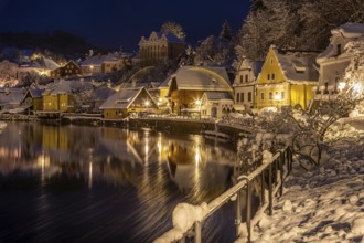 Winter view of Cesky Krumlov, picturesque houses under the castle with snow-covered roofs. Narrow