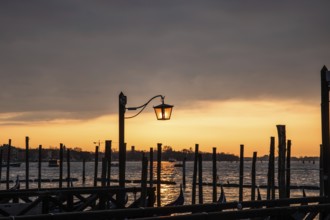 Morning atmosphere at sunrise, gondola jetty, lanterns, Venice, Italy, Europe