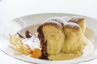 Oven-fresh Buchteln with vanilla sauce as a sweet dessert - Freisteller