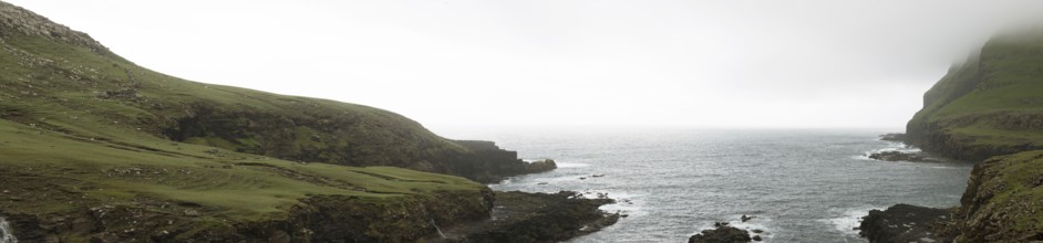 Typical landscape on the Faroe Islands, with green grass and rocks on Suduroy, Suduroy, Faroe
