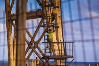 Worker climbing on a crane