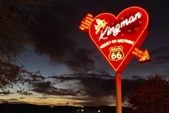 Kingman neon sign in front of a dramatic evening sky, Kingman, Arizona, USA, North America