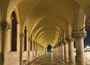 Illuminated archway of the Palazzo Ducale at night, Venice, Italy Venice, Italy, Europe