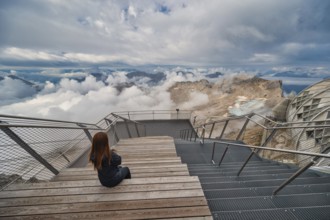 Alps mountain range view from Zugspitze Peak top of Germany with woman tourist, Garmisch