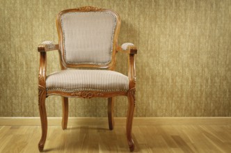 Single Old Antique Armchair Near The Wall