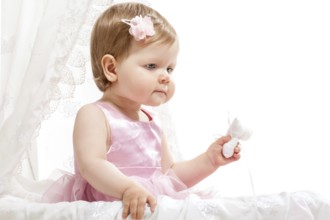 Cute little girl sitting in the baby buggy