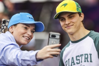MELBOURNE, AUSTRALIA - MARCH 13: Oscar Piastri of Australia and McLaren Formula 1 Team with fans