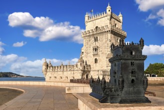 Belem tower and its scale model, Lisbon, Portugal at blue summer day sky with clouds. Medieval fort