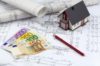 An architect's construction plan with euro money. Symbolic photo for financing and planning a new