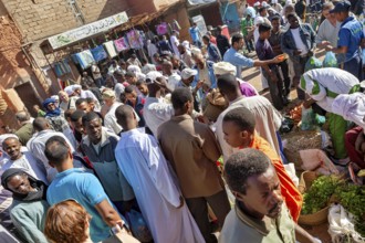 Large crowds at a lively market, surrounded by stalls and lively exchanges, The marketplace of