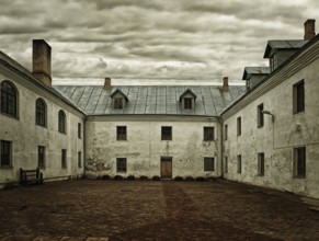 The courtyard of the monastery under a dark sky