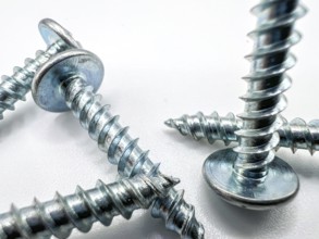 Metal screws on white background