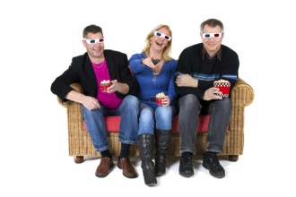 Three persons are laughing about the 3D movie on televison