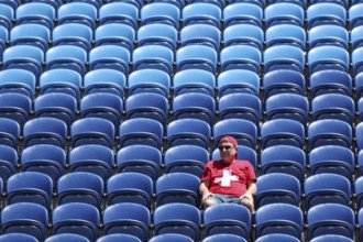 One single Swiss fan sitting in the stands watching the Australian Open 2025 junior boys singles