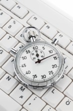 A stopwatch lies on a computer keyboard. Working time is money Austria