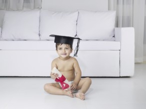 Baby holding degree certificate, MR#779O