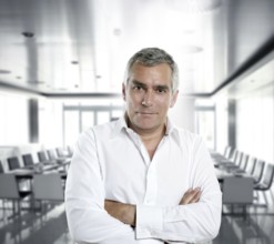 Senior expertise gray hair businessman posing interior white modern office