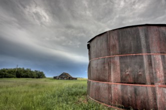 Abandoned Farm with storm clouds in the Canadian Prairie