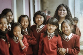 Lungdai, Mizoram, circa April 2012: Young girls dressed in red school uniforms and their teacher