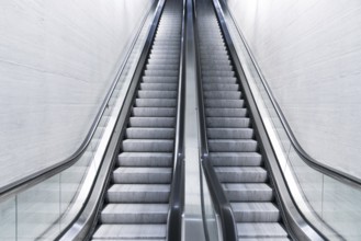 A horizontal view of an empty long escalator in a train station
